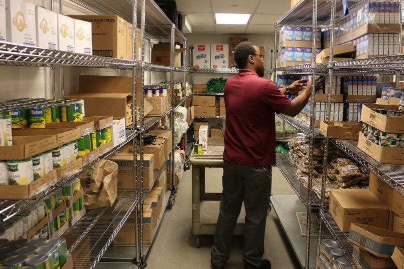 employee working in the food pantry pictured from behind