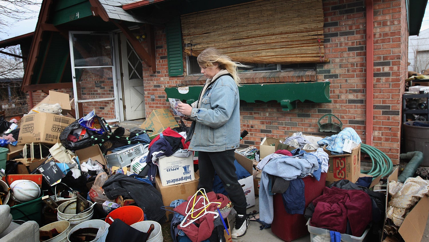 pregnant woman housing eviction with boxes outside her home