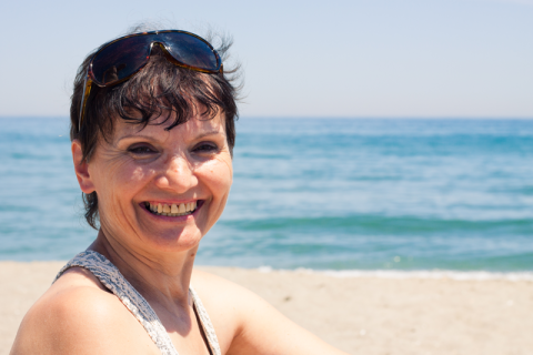 Close up of a woman smiling on the beach
